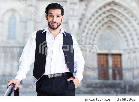 Waist up portrait of man near iron banisters 35693962