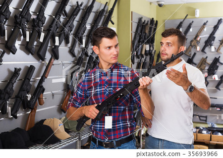 Friends choosing air-powered gun Friends choosing air-powered gun 35693966