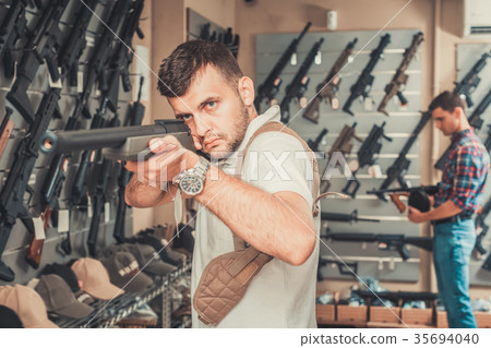 Men choosing air weapon Men choosing air weapon 35694040