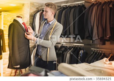 man seller measuring business style jacket 35694325