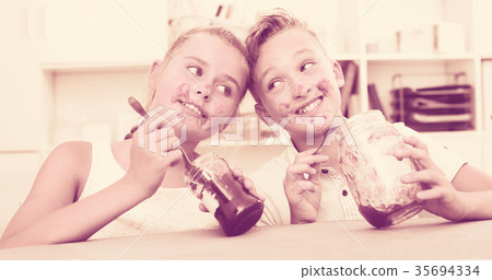Girl and boy are eating jam 35694334