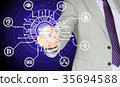 IT expert touching center of a blockchain circuit 35694588