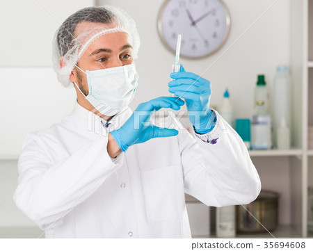 Male nurse preparing injection 35694608