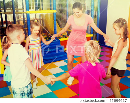 children dancing with teacher to music in class at school children dancing with teacher to music in class at school 35694617