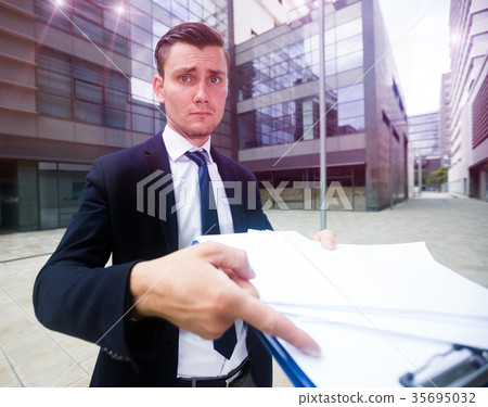 Serious manager is standing upset near office Serious manager is standing upset near office 35695032