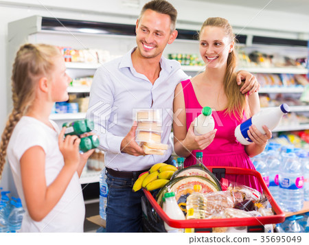 Charming family customers choosing yogurt Charming family customers choosing yogurt 35695049