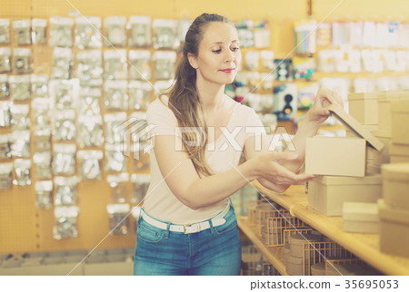 Woman is choosing small boxes for gifts Woman is choosing small boxes for gifts 35695053