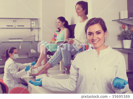 Portrait of professional nail master at working place inviting to salon 35695389