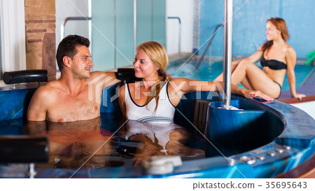 Couple relaxing in spa pool Couple relaxing in spa pool 35695643