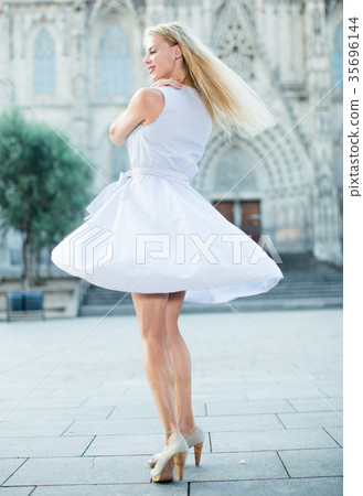 woman in the dress moving at the street 35696144