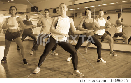 Cheerful positive people learning zumba steps 35696205