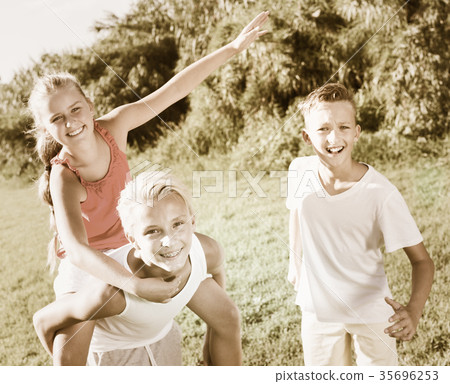 Laughing kids running on grass Laughing kids running on grass 35696253