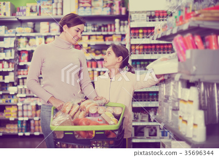 Woman with daughter in supermarket 35696344