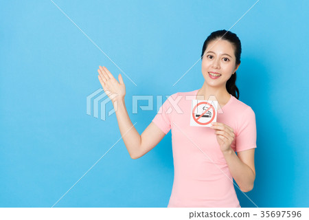 female teenager standing in blue background female teenager standing in blue background 35697596