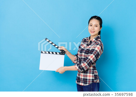 confident young female director using clapperboard confident young female director using clapperboard 35697598