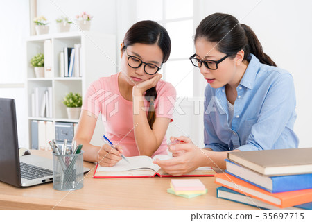 attractive college student girl doing homework attractive college student girl doing homework 35697715