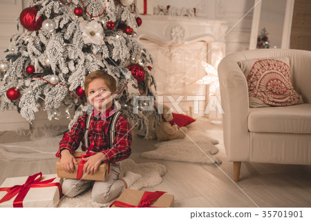 Young boy at home on Christmas evening Young boy at home on Christmas evening 35701901