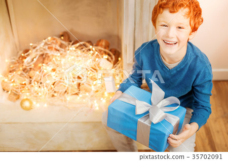 Radiant boy getting excited over christmas gift 35702091