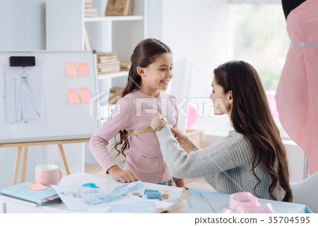 Nice cute girl standing in front of her mother 35704595