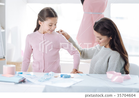 Delighted nice woman using a measure tape 35704604