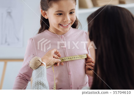 Nice professional tailor using a measure tape 35704610