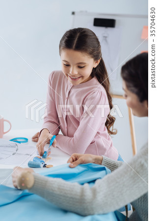 Smart curious girl learning about clothes design 35704630