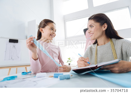 Attractive creative woman smiling to her daughter 35704718