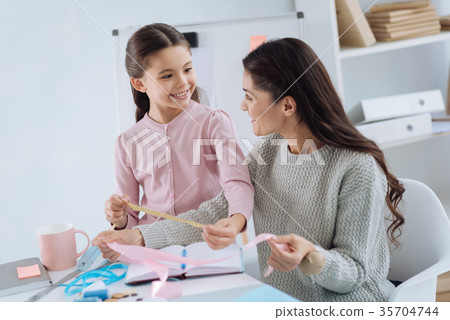 Delighted nice girl leaning how to use a tape 35704744