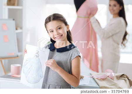 Happy smart girl showing her drawing 35704769