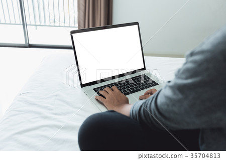 woman typing laptop keyboard showing white screen 35704813