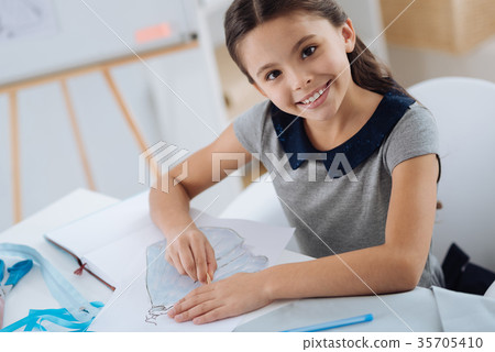 Cute positive girl making a drawing 35705410