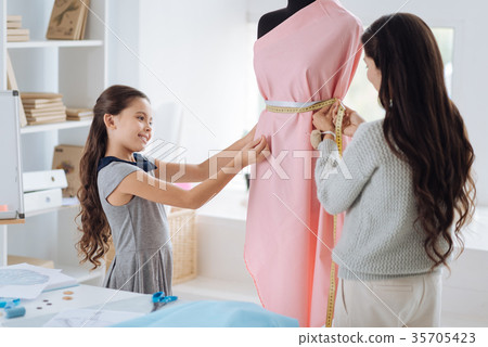 Attractive smart woman using a tape measure 35705423