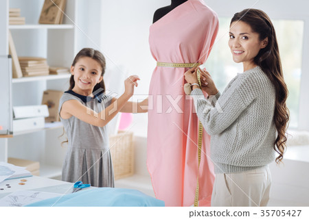 Happy nice woman making a waist measurement 35705427