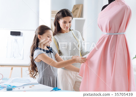 Creative nice girl designing a dress 35705439