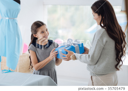 Happy nice girl receiving a birthday gift Happy nice girl receiving a birthday gift 35705479