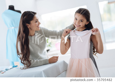 Positive young girl being happy about the dress Positive young girl being happy about the dress 35705482