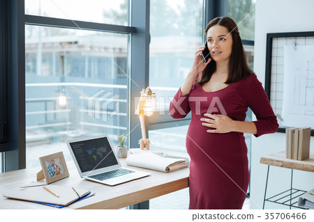 Pregnant woman concentrated on conversation 35706466