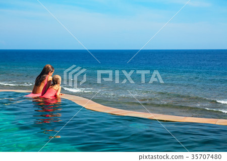 Happy mother with child in swimming pool Happy mother with child in swimming pool 35707480