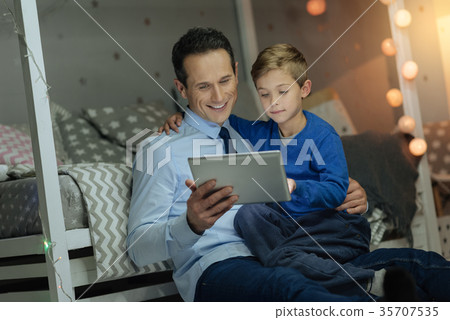 Handsome brunette man sitting with his son Handsome brunette man sitting with his son 35707535