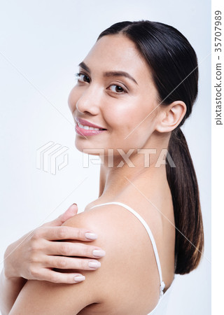 Cheerful dark-haired woman posing with hand on Cheerful dark-haired woman posing with hand on 35707989