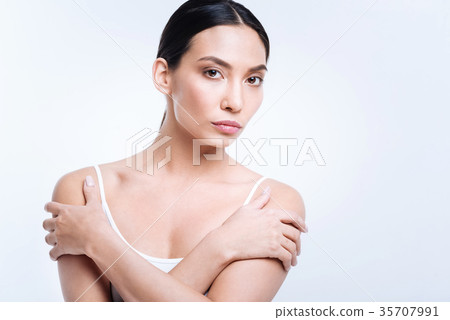 Young brunette posing with her arms crossed Young brunette posing with her arms crossed 35707991