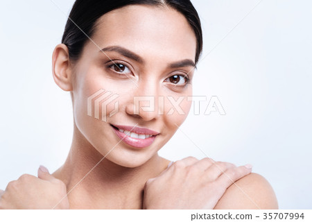 Cheerful dark-haired woman holding her hands on Cheerful dark-haired woman holding her hands on 35707994