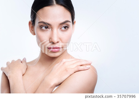 Delicate dark-haired woman posing with hands on Delicate dark-haired woman posing with hands on 35707996