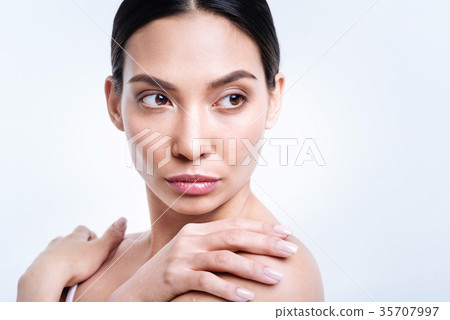 Close up of charming brunette posing against white 35707997