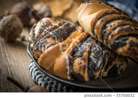 Sweet buns with poppy seed and frosting. Sweet buns with poppy seed and frosting. 35708032