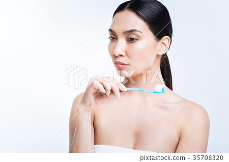 Pleasant woman pondering over something while Pleasant woman pondering over something while 35708320