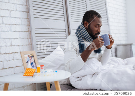 Quiet responsible patient drinking hot tea 35709026