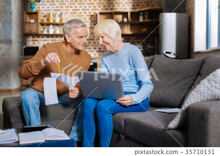 Positive elderly couple working together 35710131