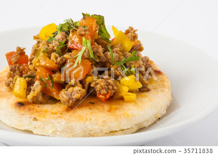 Colombian arepa topped with ground beef 35711838