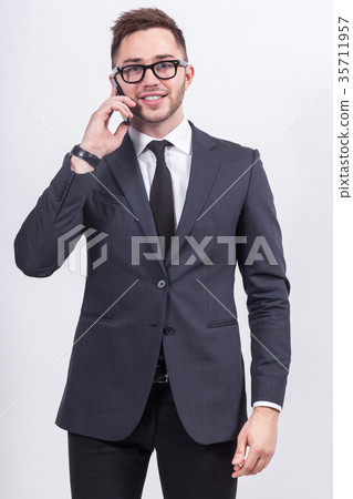 Picture of serious businessman standing  35711957